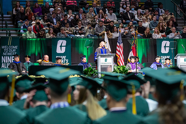 graduates sitting at UNC Charlotte commencement